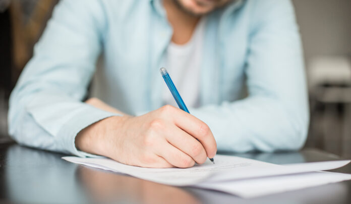 Man writing at the exam